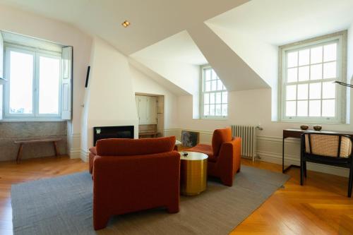 sala de estar con 2 sillas y TV en The Palace Penthouse, en Oporto