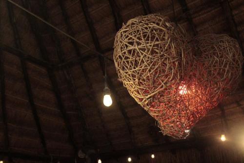 a large red heart chandelier hanging from a ceiling at Hanan Pacha in Macario Gomez