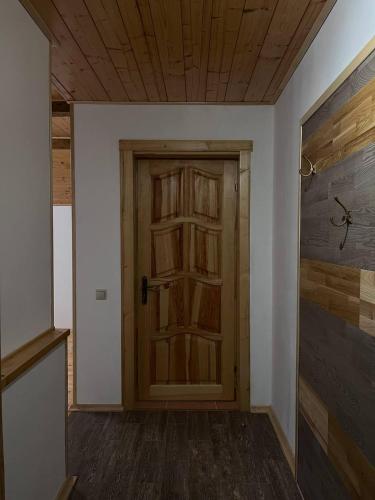 a hallway with a wooden door in a room at Hillside in Slavske