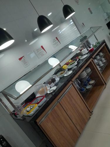 a kitchen with a counter with food on it at Mais Hotel Express in São Luís