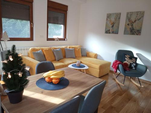 a living room with a couch and a table at Apartman Irvas Zlatibor in Zlatibor