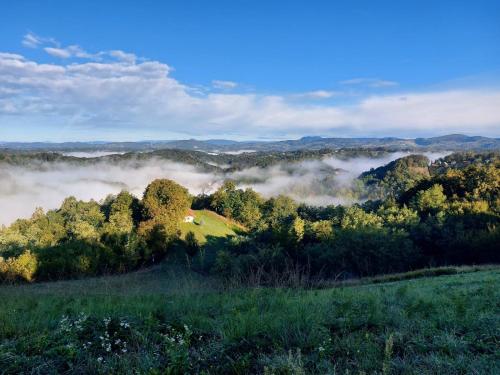 a view of a forest with fog in the hills at Kuća za odmor Freya in Krapinske Toplice
