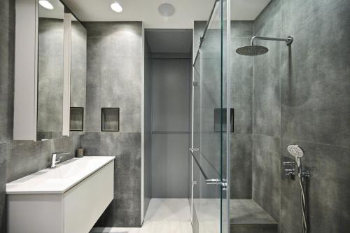 a bathroom with a shower and a sink at Modern 2BR Condo with Sea Views at Isrotel by HolyGuest in Tel Aviv