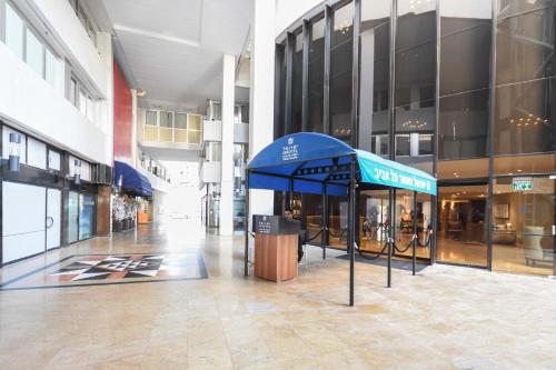 a building with a blue tent in the middle of a building at Modern 2BR Condo with Sea Views at Isrotel by HolyGuest in Tel Aviv