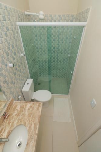 a bathroom with a toilet and a glass shower at ALIZE CUMBUCO in Cumbuco