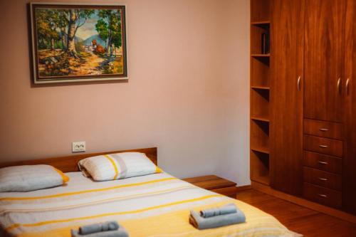 a small bedroom with a bed and a closet at Villa Natura,a private villa next to a picturesque lake near Vratsa 