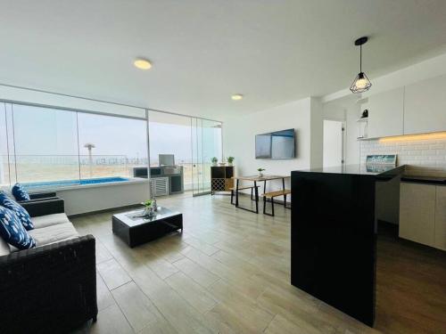 a large living room with a couch and a table at A 3 minutos de la Playa Hermoso Departamento con Piscina y Parrilla in Asia