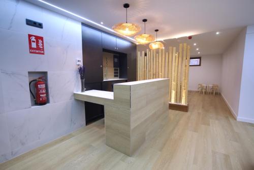 a lobby with a counter in the middle of a room at HAVANAAPARTAMENTOS in Puerto de Vega