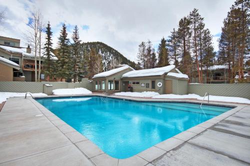 a swimming pool in front of a house at The Forest Neighborhood by Keystone Resort in Keystone