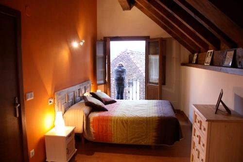 a bedroom with a large bed and a window at IKUILU Ochagavia-Selva de Irati in Ochagavía