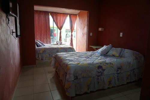 Un pat sau paturi într-o cameră la Velaria