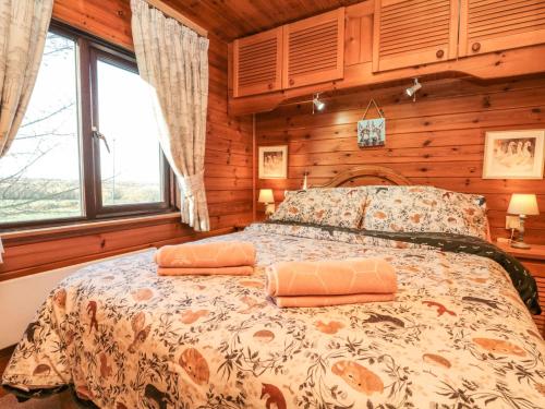 a bedroom with a bed in a room with wooden walls at Holly Lodge in Saltburn-by-the-Sea