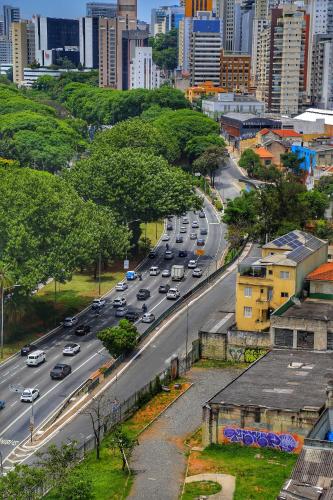 a busy city street with cars driving down a road at Residencial Bella Vista Suites in Sao Paulo