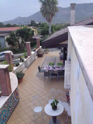 a patio with tables and chairs on a building at Il Tuffatore B&B in Capaccio-Paestum