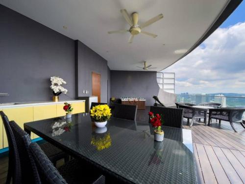 a dining room with a table with flowers on it at The Luxury Penthouses Kuala Lumpur in Kuala Lumpur
