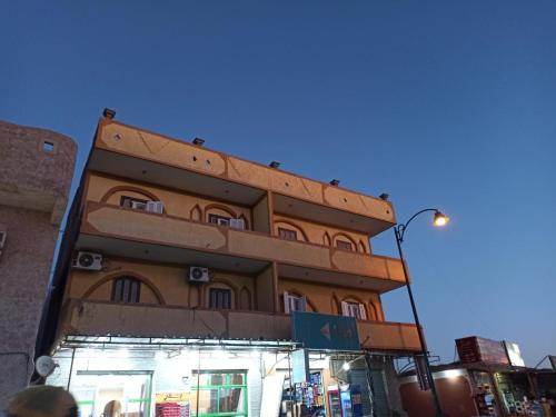a tall building on the side of a street at Al-Manara Hostel Siwa Oasis in Siwa