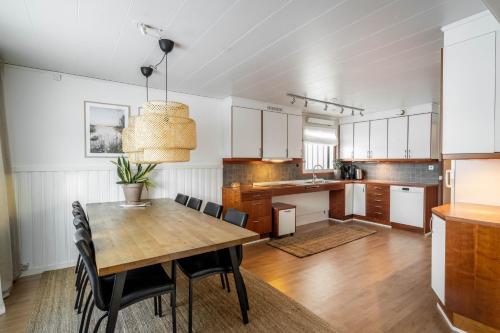 a kitchen and dining room with a wooden table and chairs at Spacious Villa located in Beautiful High Coast in Domsjö