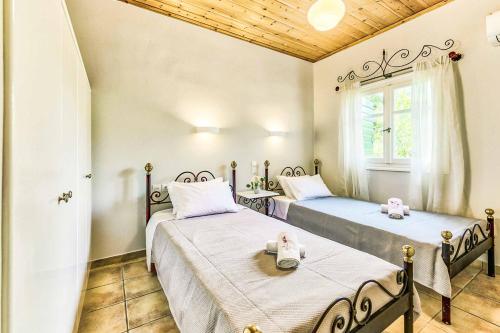 Postel nebo postele na pokoji v ubytování Villa Helona