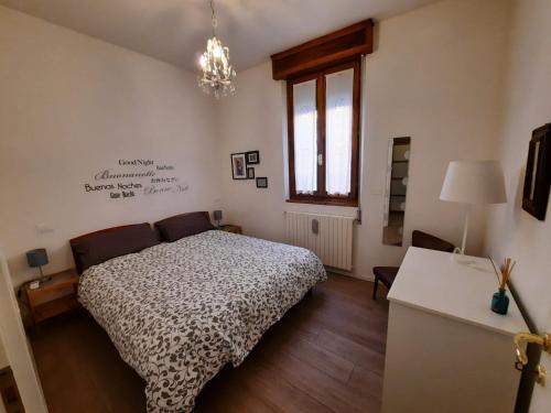 a bedroom with a bed and a table and a window at Ca' Rosone in Imola