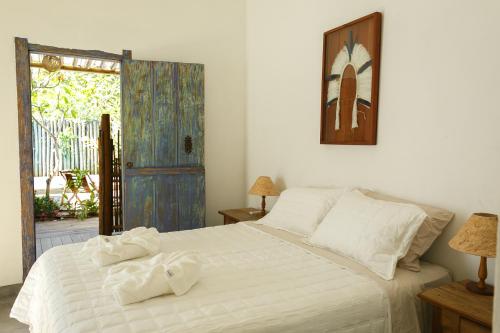 Кровать или кровати в номере Arandu Casa Hotel Colina Trancoso