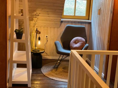 ein Treppenhaus mit einem Stuhl in einem winzigen Haus in der Unterkunft Chalet am Bach in Deutschgriffen