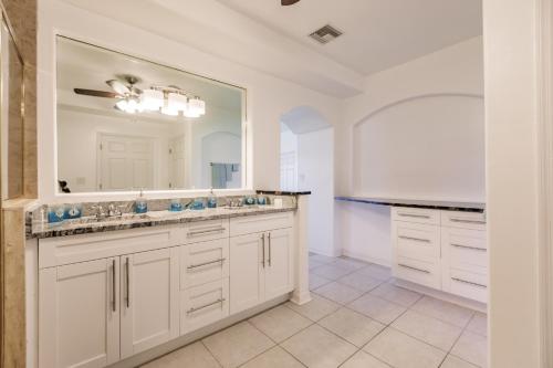 a bathroom with two sinks and a large mirror at NEW! Dock Canal Family Home w/Pool & Gulf Access! in North Fort Myers