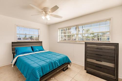 a bedroom with a bed and a ceiling fan at NEW! Dock Canal Family Home w/Pool & Gulf Access! in North Fort Myers