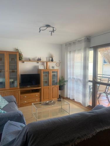 a living room with a couch and a glass coffee table at Peñas de Aia in Jaca