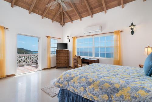 a bedroom with a bed and a view of the ocean at Fort Shelley in Cades Bay