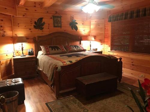 a bedroom with a bed in a log cabin at Glens of Antrim Mountain Cabin in Waynesville