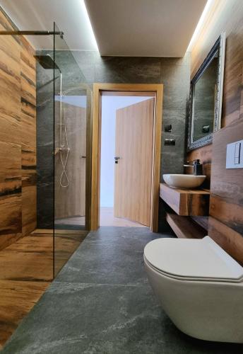 a bathroom with a toilet and a sink at Apartamenty Nowa Osada - by VillaOlimpijska2 in Wisła