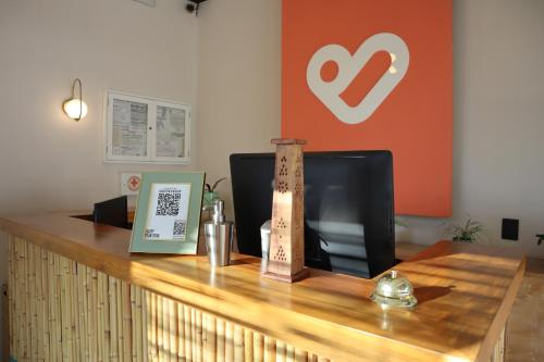a wooden counter top with a television on it at 3B Wellness Hostel in Playa del Carmen