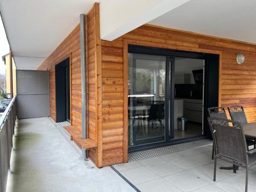 a house with sliding glass doors on a patio at La Niche 2 in Brides-les-Bains
