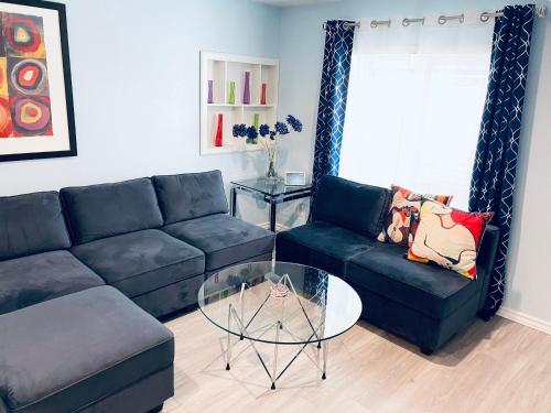 a living room with a couch and a glass table at Artsy home by Air Force Academy with office space in Colorado Springs