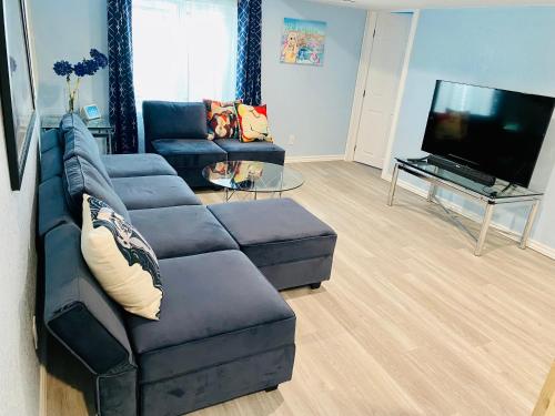 a living room with a couch and a flat screen tv at Artsy home by Air Force Academy with office space in Colorado Springs