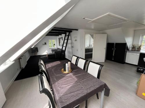 a dining table and chairs in a living room at 3 værelses lejlighed med hems - 4 in Kolding