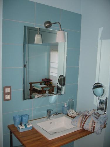 a bathroom with a sink and a mirror at Le Presbytère de Vieuvy in Vieuvy