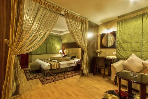 a hotel room with a bed and a desk at Hotel Gateway Grandeur in Guwahati