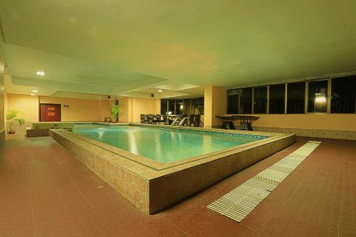 a large swimming pool in a building at Hotel Gateway Grandeur in Guwahati