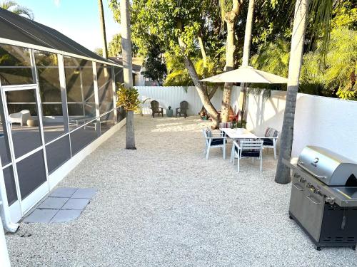 a patio with a grill and a table and chairs at Home in Miami in Miami