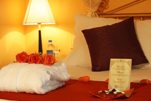 a bed with a towel with roses on it at City Art Hotel Silberstein in Quito