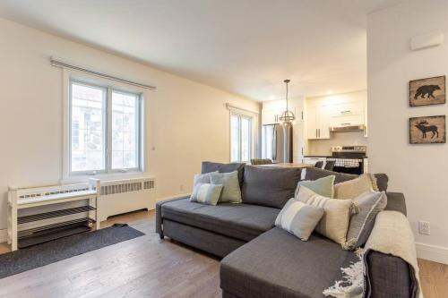 a living room with a couch and a kitchen at Free Parking, Beautiful 4 1/2-2 BR apartment in Montréal