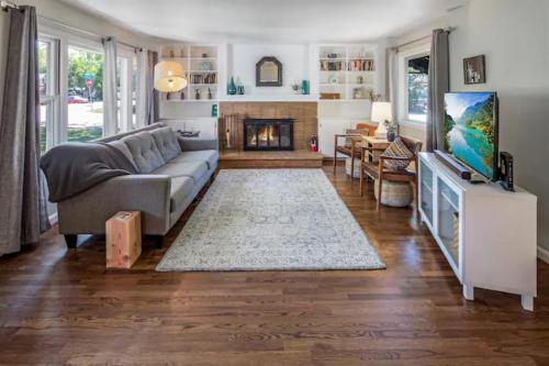 a living room with a couch and a fireplace at Celebration Chalet! Quant, cozy, a few blocks from BSU and close to downtown Boise, Fireplace, 4 beds, and seating for 6 Pets Welcome! in Boise