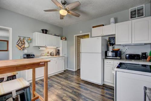 a kitchen with white cabinets and a white refrigerator at Red Bench Cottage Ideal location near parks, trails, skiing, hiking, biking, shopping extended stays welcome in Boise