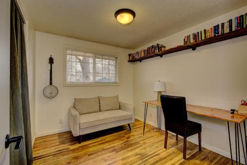 a living room with a desk and a chair at Sunset Home perfect for extended stays with fully fenced in yard, designated office, two living rooms, located across from Boise Foothills and close to Bogus Basin in Boise's North End in Boise