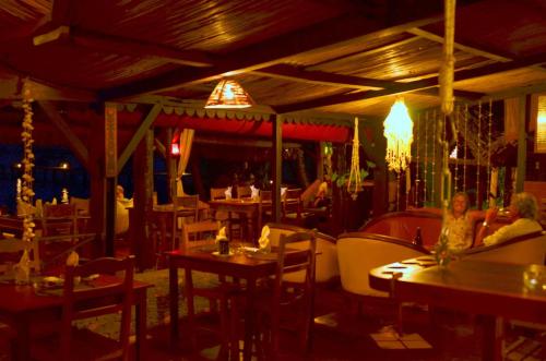 two women sitting at tables in a restaurant at Libertalia Hotel in Sainte Marie