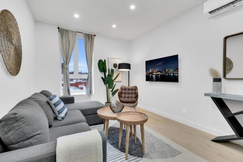 a living room with a couch and a table at Deluxe Suites Downtown Montreal in Montréal