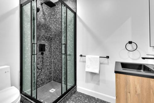 a shower with a glass door in a bathroom at Deluxe Suites Downtown Montreal in Montreal