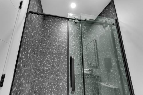 a shower with a glass door in a bathroom at Deluxe Suites Downtown Montreal in Montréal