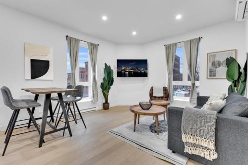 a living room with a couch and a table at Deluxe Suites Downtown Montreal in Montréal